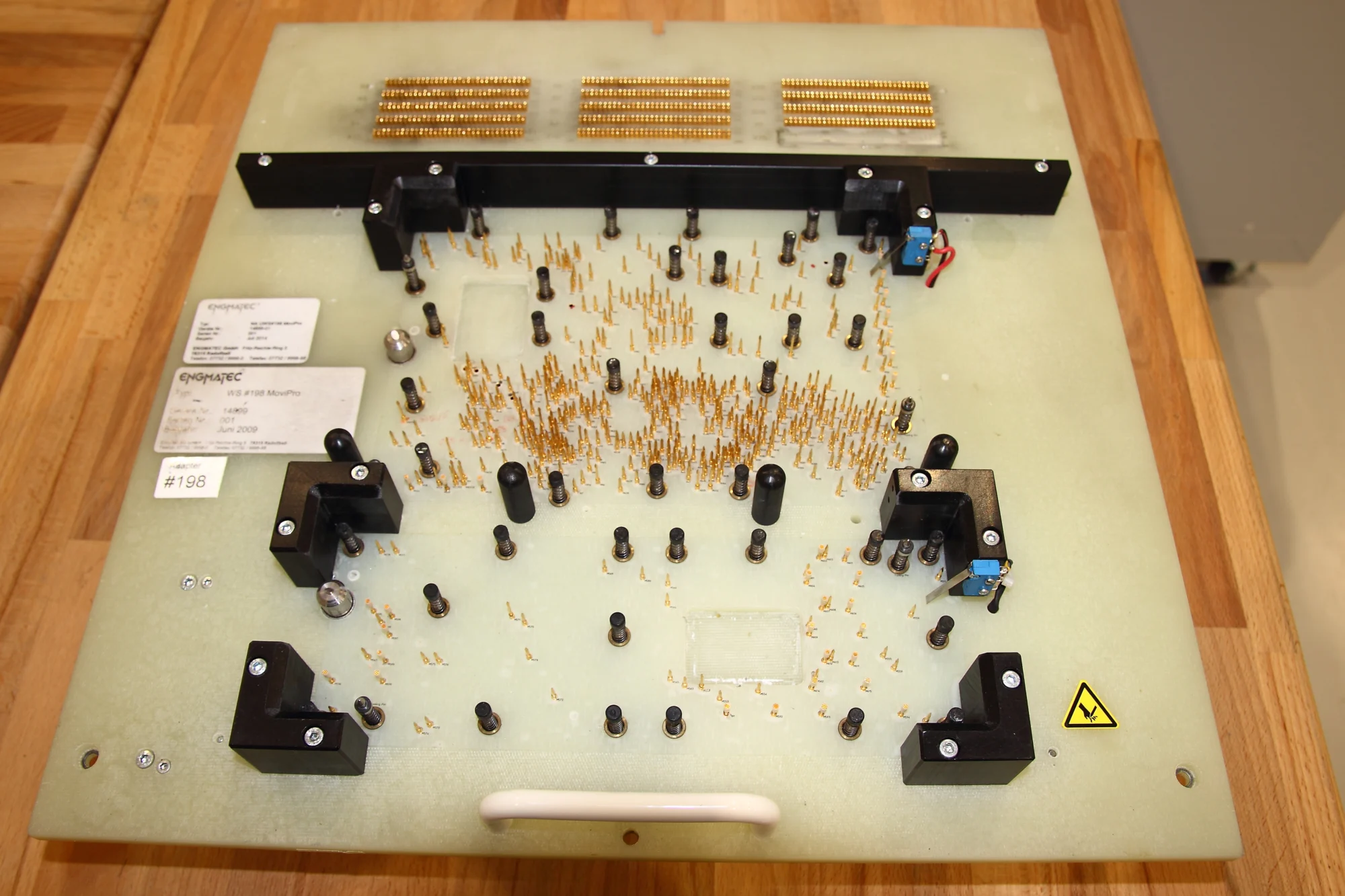 Contact-pin assembly with brackets on a base plate